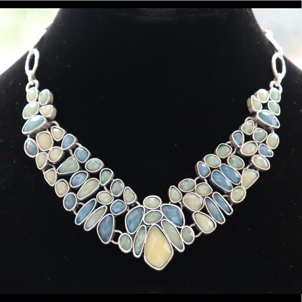 REVERSIBLE NECKLACE IS SILVER METAL ON ONE SIDE WITH INLAID COLORED STONES